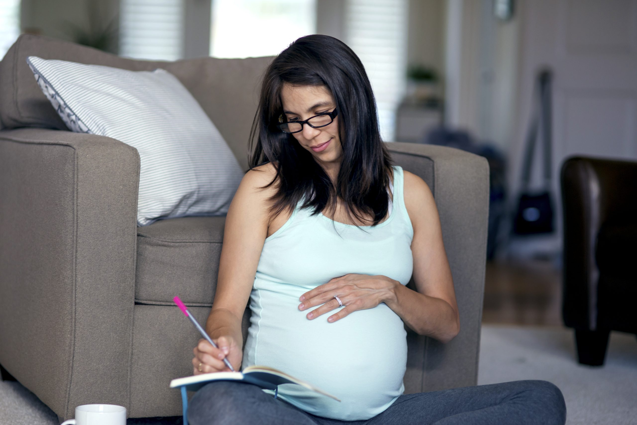 pregnant woman journaling about giving up a baby for adoption in Arizona
